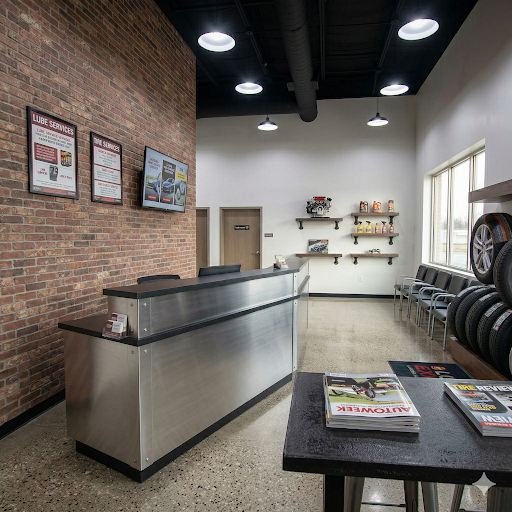 Service center waiting area with modular seating and a metal-clad reception desk