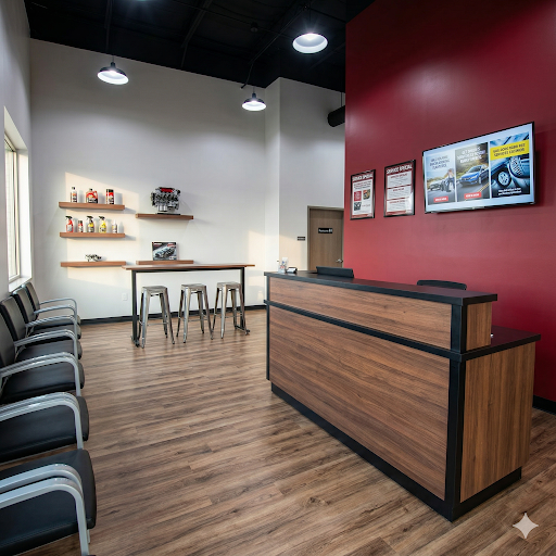 Automotive service center lobby with a wood-clad reception desk and customer seating area